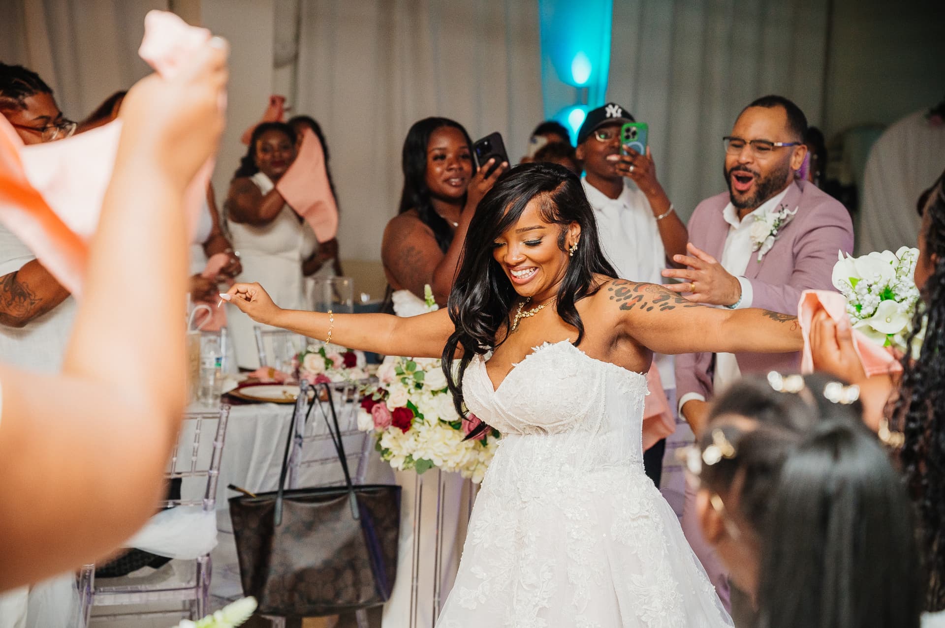 Bride dancing joyfully with wedding guests at the reception